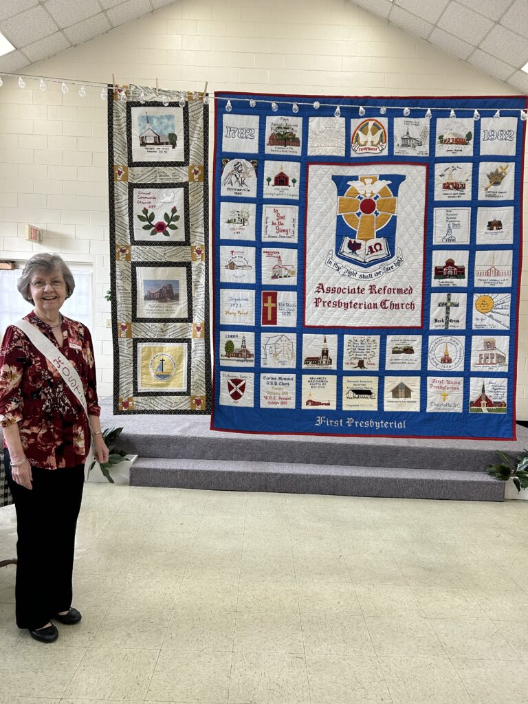 Mary Lineberger pictured with First Presbyterial quilt